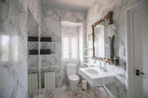 a white bathroom with a sink and a toilet at Villa Dora in Jávea