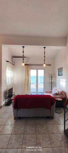 a bedroom with a large bed and a large window at Green Boat House in Skala