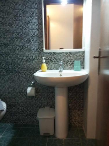 a bathroom with a sink and a mirror at Studios Tripiti in Nea Roda