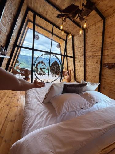 a bed in a room with a large window at Montecielo in Pitalito