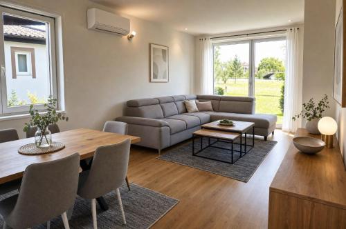 a living room with a couch and a table at Sarajevo Resort Gestoria in Hadžići