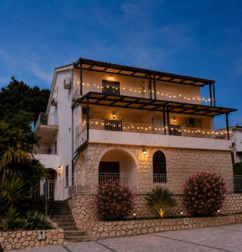 a large white building with lights on it at Apartment RB in Omišalj