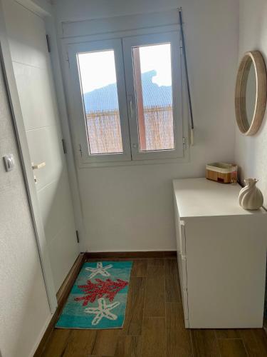 a room with a refrigerator and a window and a rug at Kallisti House in Nea Vrasna