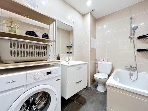 a white laundry room with a washer and dryer at L'R du Temps 2 - Clim, Centre-ville, 6 personnes, 4 lits in Istres