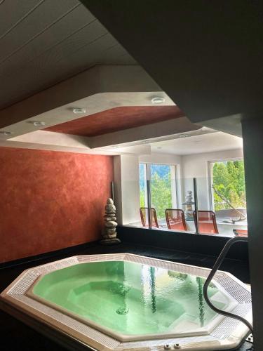 a hot tub in a room with at Cozy Studio with Wellness in Goms in Blitzingen