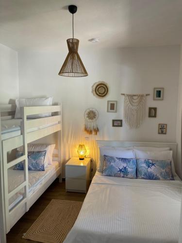 a bedroom with two bunk beds and a lamp at Kallisti House in Nea Vrasna