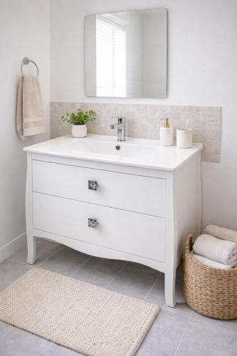 a bathroom with a white sink and a mirror at EL PRINCIPE in Zaragoza
