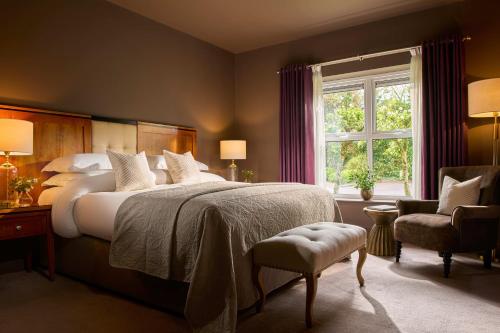 a bedroom with a large bed and a window at Brook Lane Hotel in Kenmare