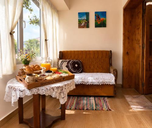 a living room with a table with a tray of food at GRANDPA's HOME in Pusteci