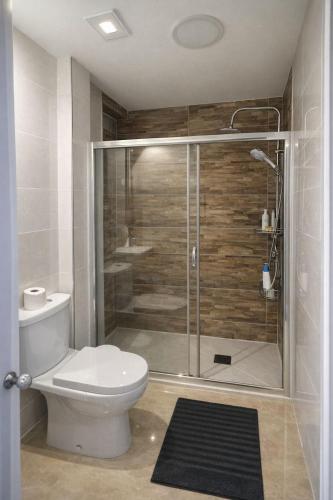 a bathroom with a toilet and a glass shower at EL PRINCIPE in Zaragoza