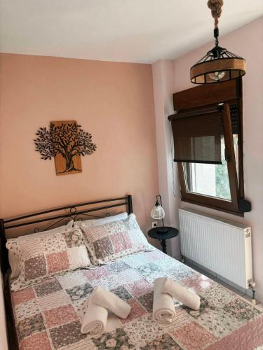 a bedroom with a bed with two slippers on it at Sofia in Komotini