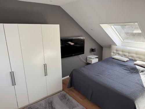a bedroom with a bed and a flat screen tv at Ferienwohnung Monteurwohnung in Lüdenscheid