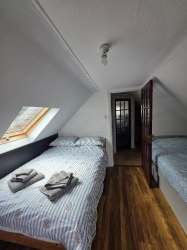 a bedroom with a bed with towels on it at The Coastal Nest in Folkestone