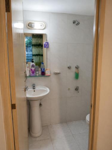 a bathroom with a sink and a shower at One Private Room Near Dhaka Airport in Dhaka