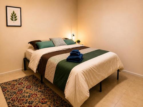 a bedroom with a bed with a blue towel on it at DOLFIJN STUDIOS 4 Spacious 2BR Apartment Fast WiFi AC North Paramaribo in Paramaribo