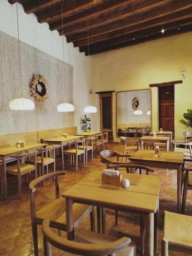 a dining room with wooden tables and chairs at Hotel Boutique Morada De Paz in Real de Catorce