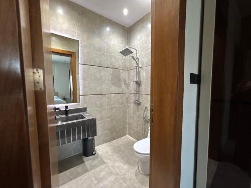a bathroom with a sink and a toilet at Toot Suites in Abha