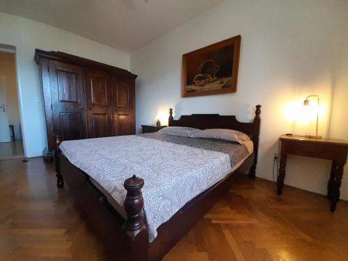 a bedroom with a bed and a wooden floor at Vake in Herceg-Novi