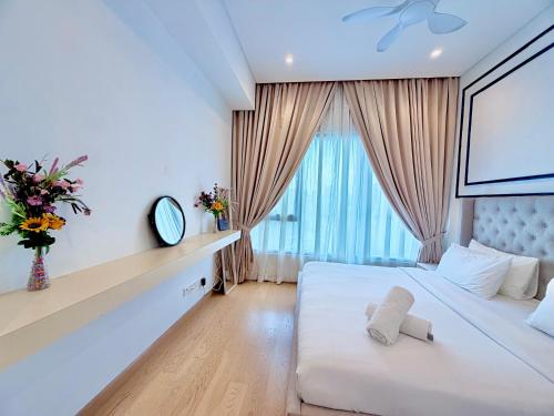 a bedroom with a white bed with a teddy bear on it at Lucentia residence luxury suites in Kuala Lumpur