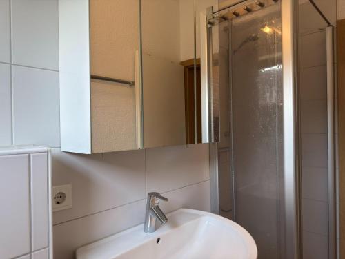 a bathroom with a sink and a shower at Ferienwohnung in Burhave in Burhave