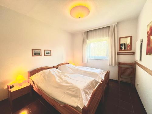 a bedroom with a bed and a window at Cozy cottage in Lichtenau