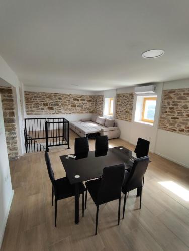 a living room with a table and chairs and a couch at Roman Paradise Villa with Pool in Koper