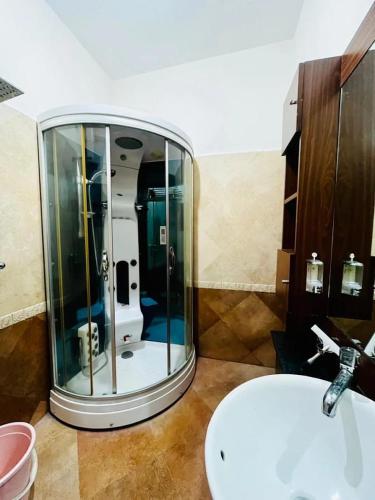 a bathroom with a round mirror next to a sink at U K I Guest House in Bangalore