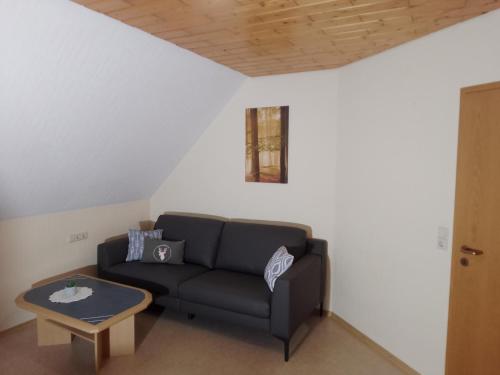 a living room with a couch and a table at Apartment in Hofstetten surrounded by nature in Hofstetten
