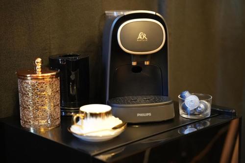 a coffee maker sitting on a table with other items at Dahlia suite & spa in Nîmes