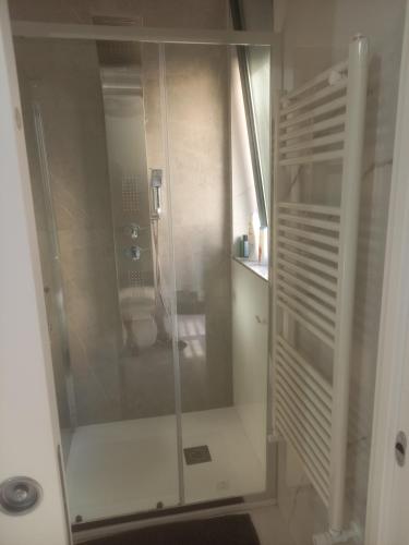 a shower with a glass door in a bathroom at BEB LA Perla in Sammichele di Bari