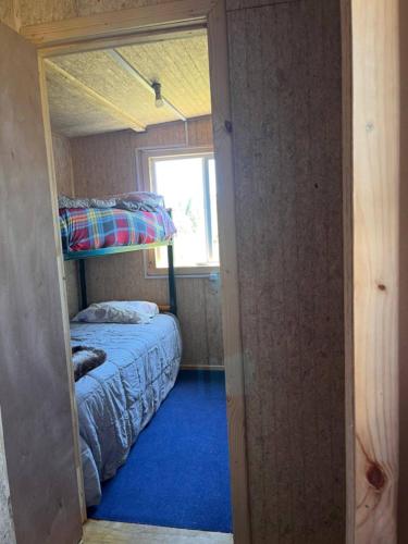 a bedroom with two bunk beds and a window at Cabañas y tinajas in Ancud
