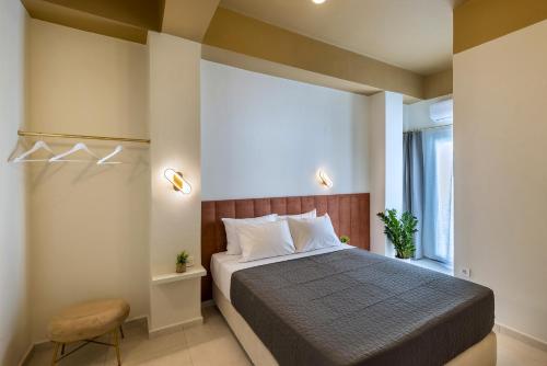 a bedroom with a bed and a chair and a window at Alexander Seaview Haven in Ermoupoli
