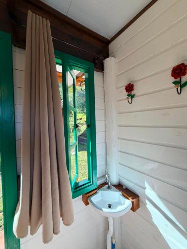 a bathroom with a sink and a window at Linha Nova Glamping in Gramado