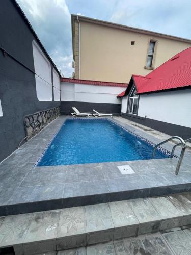 a swimming pool in front of a building at Gabala Home in Gabala