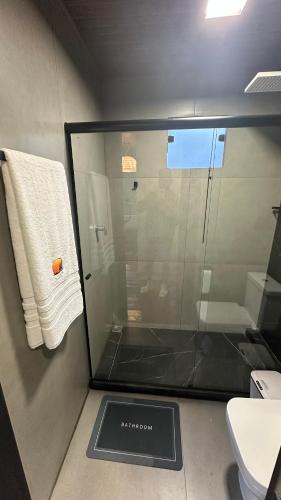 a bathroom with a glass shower and a toilet at Forest in Domingos Martins