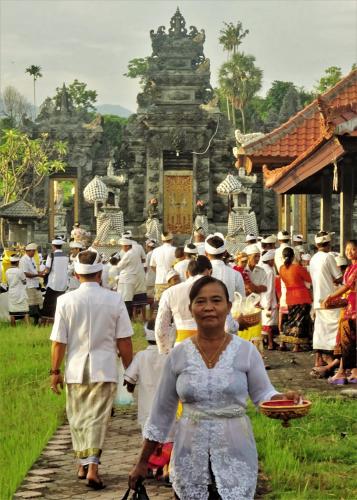 a group of people walking in front of a temple at Mayo Resort in Umeanyar