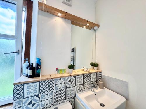 a bathroom with a sink and a mirror at The Castle Front Nest in Inverness