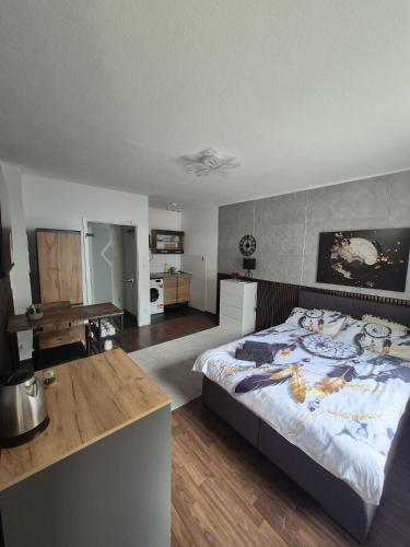 a bedroom with a large bed with a painting on the wall at Cozy & Elegant Central Apartments in Hannover