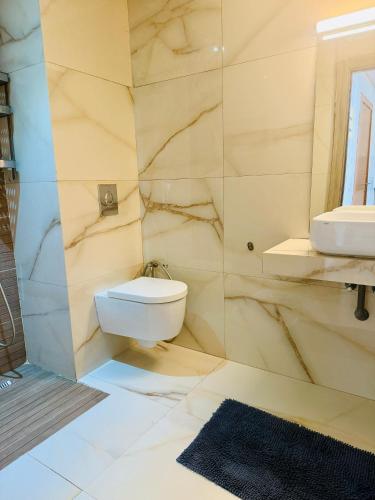 a bathroom with a white toilet and a sink at Islane Holiday Studio with pool&balcony in Agadir