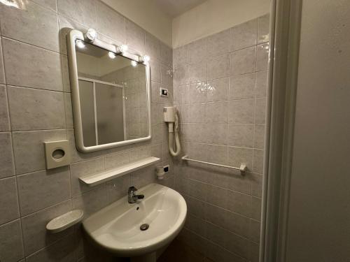 a bathroom with a sink and a mirror at Hotel du Foyer Brusson in Brusson