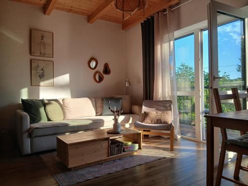 a living room with a couch and a coffee table at Vulcanus Apartment in Badacsonytomaj