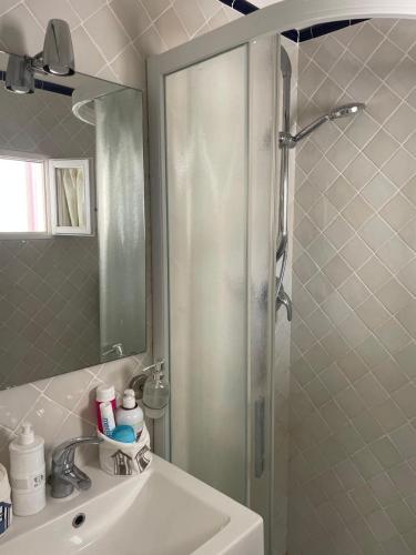 a bathroom with a shower and a sink with a mirror at Smartop Apartment in Forte dei Marmi