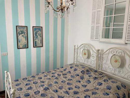 a bedroom with a bed and three pictures on the wall at Smartop Apartment in Forte dei Marmi