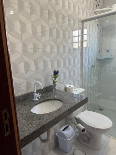 a bathroom with a sink and a toilet and a shower at Ap 07 mazzonetto in Primavera do Leste