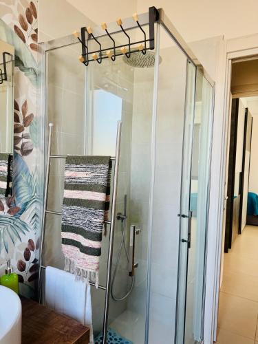 a shower with a glass door in a bathroom at Sole di Sicilia in Locogrande