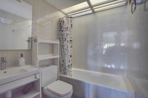 a bathroom with a toilet and a sink and a shower at Casa Bon Matí in L'Ampolla