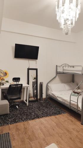 a bedroom with a bed and a desk and a chair at Mactan Cozy Hub Amani Grand in Lapu Lapu City