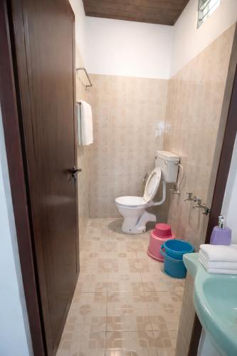 a bathroom with a toilet and a sink at Misty D Silver in Munnar