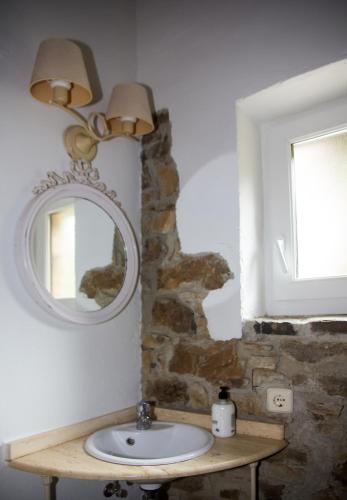 a bathroom with a sink and a mirror at Armaño Rural (G-10069) in Tama