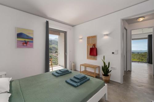 a bedroom with a bed with two blue pillows on it at Mediterra Messinia in Kalamata